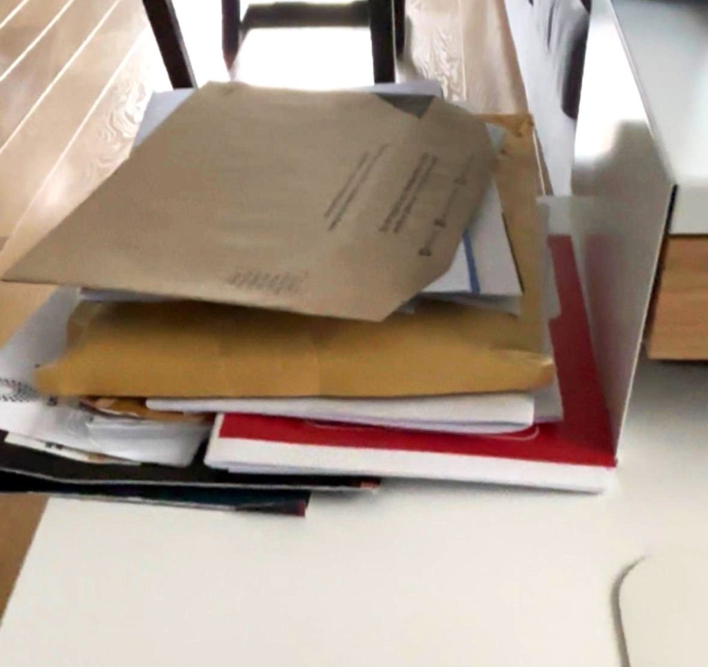 Pile of paperwork at home waiting to be organised